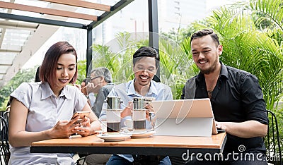 Three friends using devices connected to the wireless internet n Stock Photo
