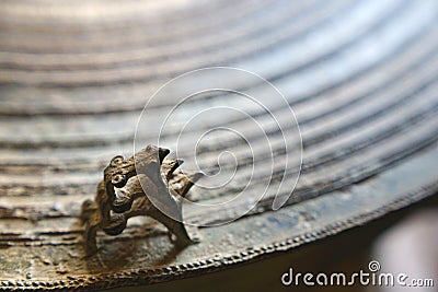 Three frogs on surface of ancient bronze drum. Frog drum Stock Photo