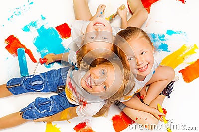 Three funny girls sitting on a floor Stock Photo
