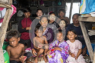 Three generation of Bajau tribe sit inside their wooden hut. Editorial Stock Photo