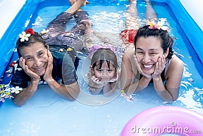 Three generation people swimming in Inflatable Pool at the summer time Stock Photo