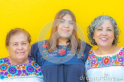 Three generations of Mexican women smiling, grandmother, granddaughter and mother Stock Photo