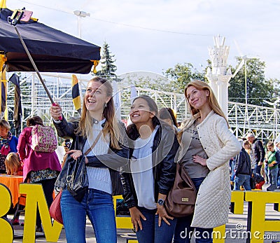 Three girls taking a selfie in a city park Editorial Stock Photo