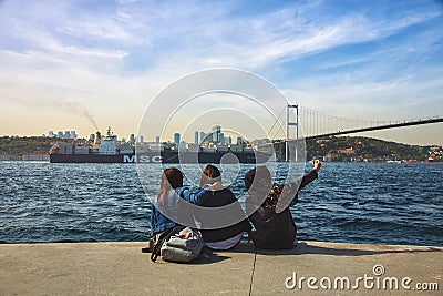 Three girls in Uskudar and the Bosphorus Bridge Editorial Stock Photo