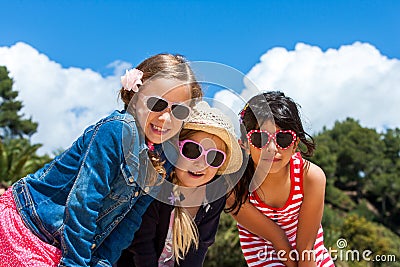Three girls wearing sunglasses. Stock Photo