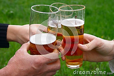 Three glass with beer in men hands Stock Photo