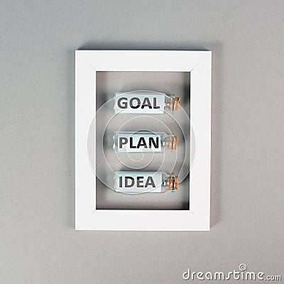 Three glass bottles with the words idea, plan and goal in a frame, education, marketing and business concept, brainstorming Stock Photo