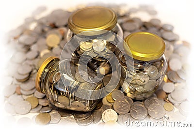 Three glass jars full of coins Stock Photo