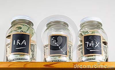Three glass jars on wooden shelf for savings Stock Photo