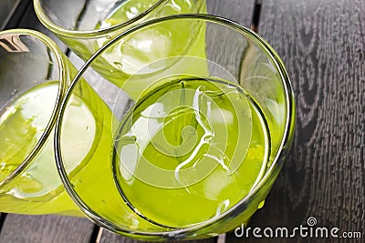 Three glasses of cold lemonade tarragon kiwi lime. Stock Photo