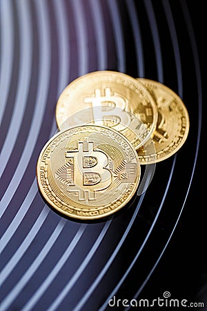 Three gold coins bitcoin on a black background Stock Photo