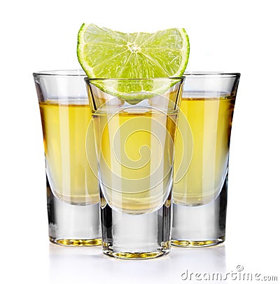 Three gold tequila shots with lime isolated on white Stock Photo