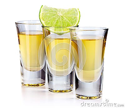 Three gold tequila shots with lime isolated on white Stock Photo