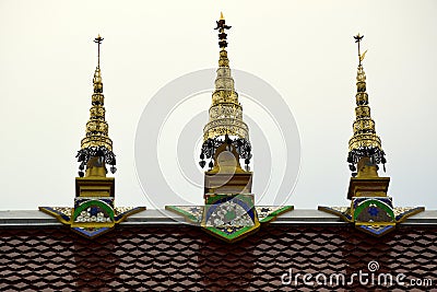 Three Golden Spires on a Temple Roof in Thailand Stock Photo