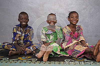 Three Gorgeous African Black Schoolboy and Schoolgirls Sitting Indoors Stock Photo