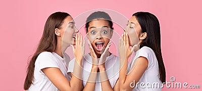 Three Gossip Girls Whispering Secrets Standing In Studio, Panorama Stock Photo