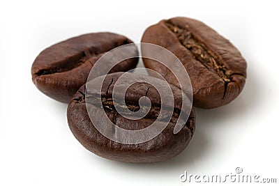 Three grains of black arabica coffee on an isolated white background. Macro photo Stock Photo