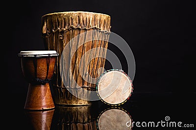 Three handmade Djembe drums isolated on black Stock Photo