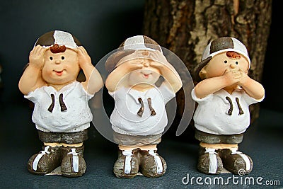 Three handmade figurines that represent: hear, see and remain silent. Stock Photo