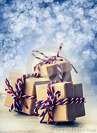 Three handmade gift boxes in shiny colour background. Stock Photo