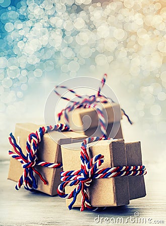 Three handmade gift boxes in shiny colour christmas background Stock Photo