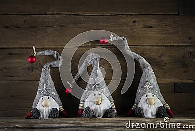 Three handmade imps on wooden background wearing santa hat for c Stock Photo