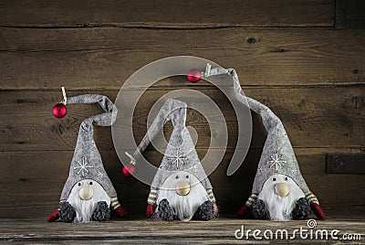 Three handmade imps on wooden background wearing santa hat for c Stock Photo