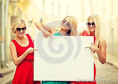 Three happy blonde women with blank white board Stock Photo