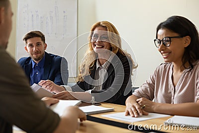 Three happy HR businessman and businesswoman speaking during work interview. Stock Photo