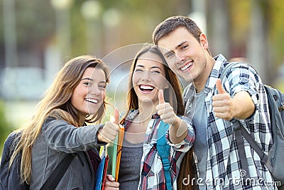 Three happy students with thumbs up Stock Photo