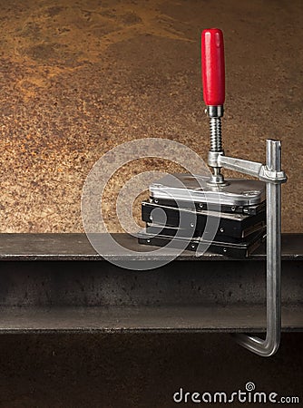 Three hard drives pressed together with a clamp Stock Photo