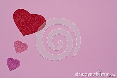 Three hearts on pink background Stock Photo