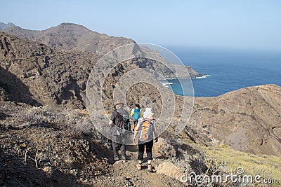 Three hikers on a trail in the north of La Gomera, Canary Islands Editorial Stock Photo