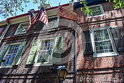 Three historic American Flags on the side of old brick buildings Stock Photo