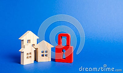 Three houses and a red padlock. Unavailable and expensive real estate. house Insurance. Security and safety. Confiscation Stock Photo