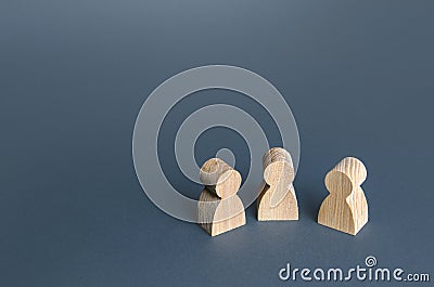 Three human figurines. Communication and discussion. Friendly relations. A meeting. Assistance Stock Photo