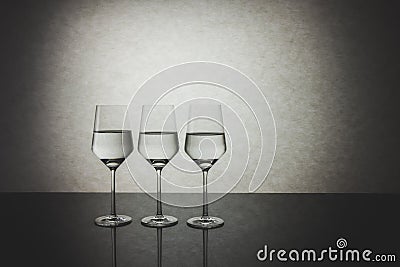 Three Identical Crystal Glasses of Water Half Filled Stock Photo