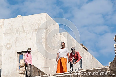 Three Indian men on a rooftop Editorial Stock Photo