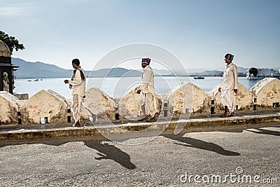 Three indian men walk equidistant to each other, Udaipur Palace Editorial Stock Photo