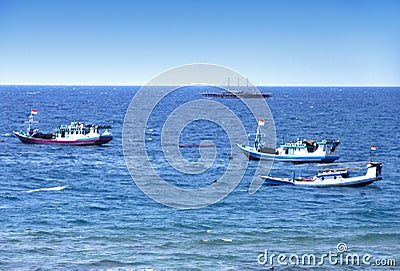 three Indonesian fishing boats are fishing in the middle of the sea Stock Photo