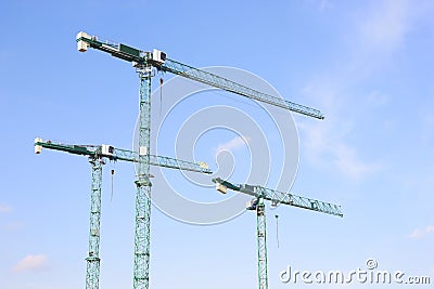 Three industrial construction tower cranes. Stock Photo