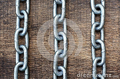 Three iron chain on the wodden background Stock Photo