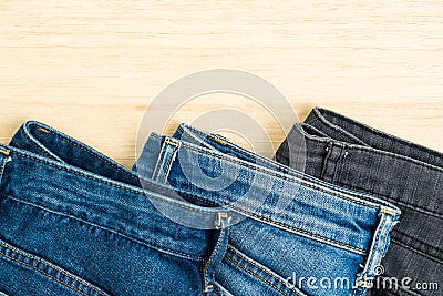 Three jeans denim on wood background Stock Photo