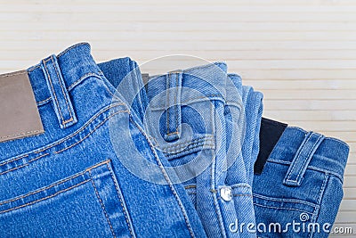 Three jeans in different blue shades on a light background.Selective focus.Concept of denim texture clothing wardrobe selection Stock Photo
