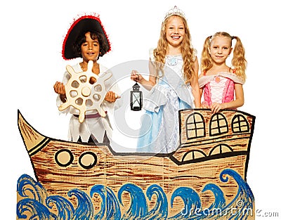 Three kids, pirate and princess on cardboard ship Stock Photo