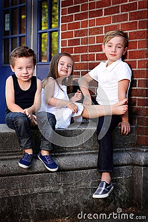 Three Kids Sitting Stock Photo