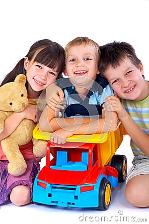 Three kids and their toys Stock Photo