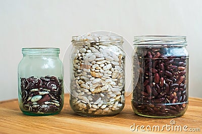 Three kind of sorts of beans in glass jars Stock Photo