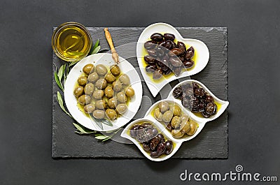 Three kinds of selected olives and olive oil. Stock Photo