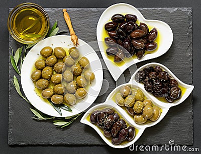 Three kinds of selected olives and olive oil. Stock Photo